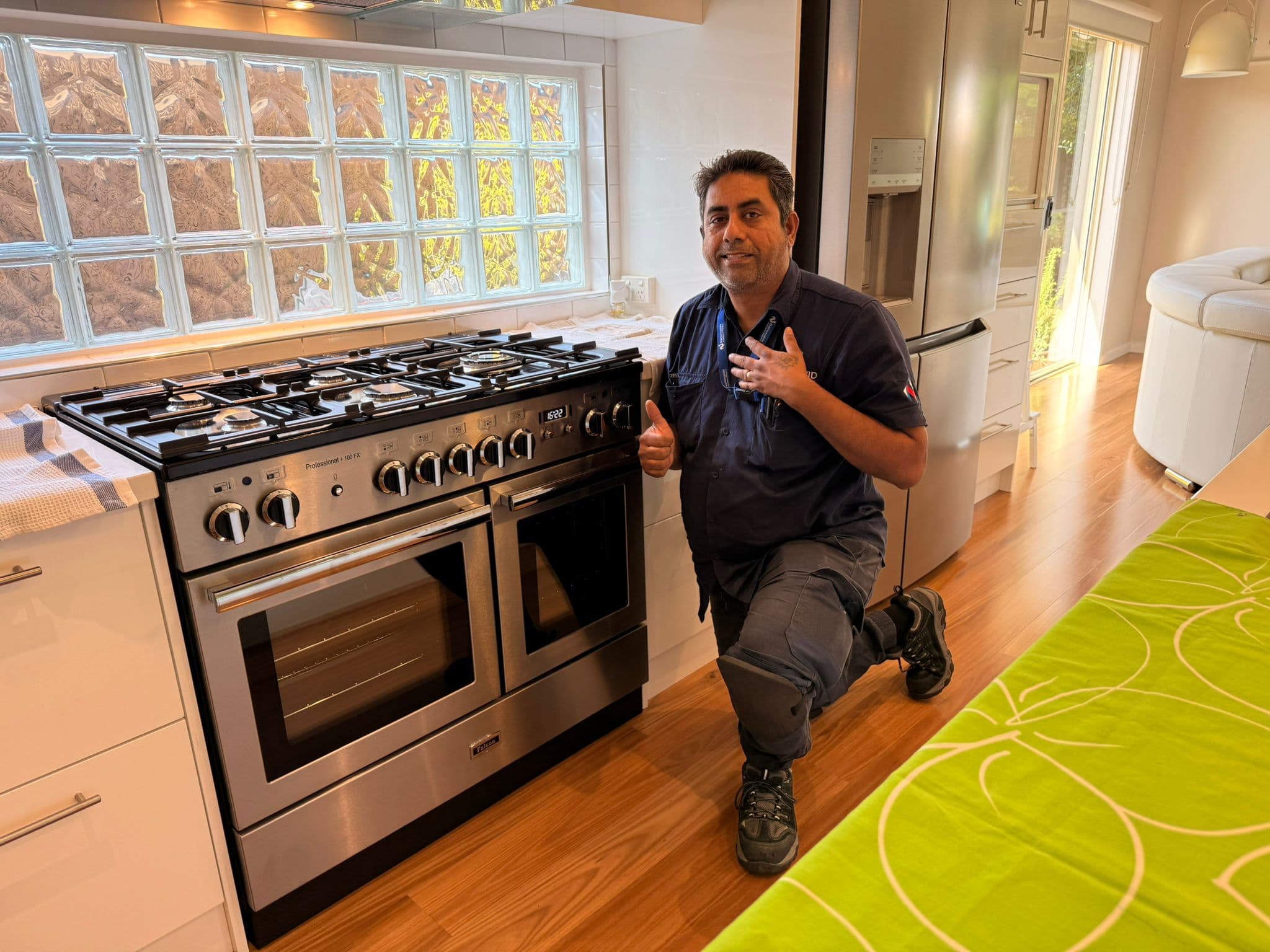 Completed gas range repair - technician thumbs up